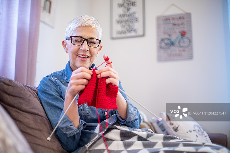 中年妇女正在为冬天制作一条温暖的围巾图片素材
