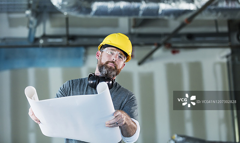 在建筑中查看计划的建筑工人图片素材