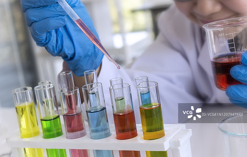 实验室概念：科学家用滴管转移化学试剂图片素材