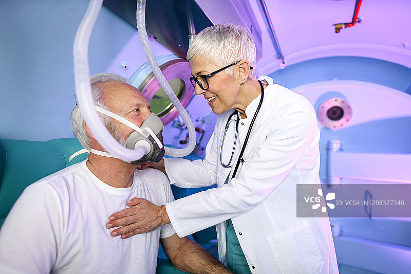年长的女医生在高压氧舱内检查病人图片素材