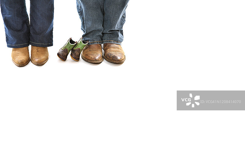 两双成人牛仔靴和一双婴儿牛仔靴特写图片素材