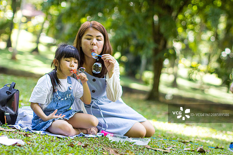 母亲和女儿一起吹泡泡图片素材