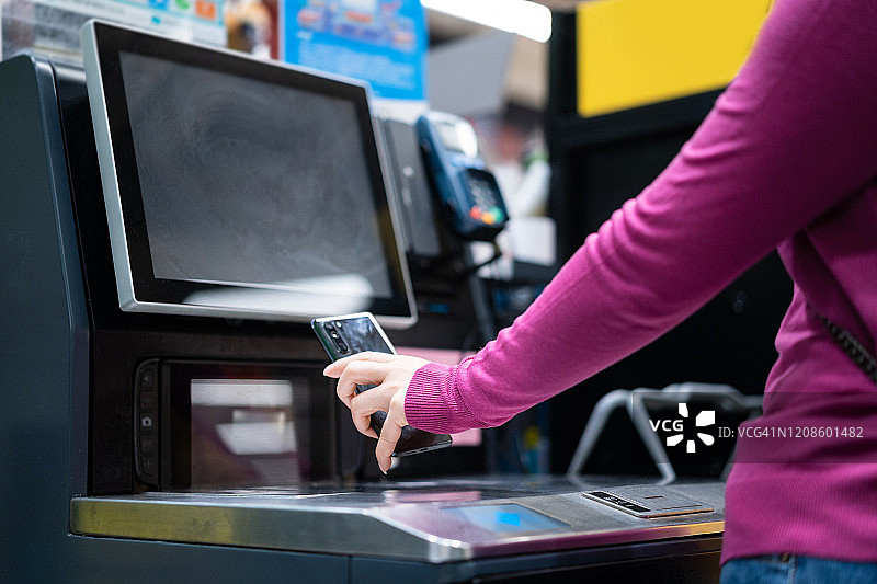 女人使用手机进行非接触式支付图片素材