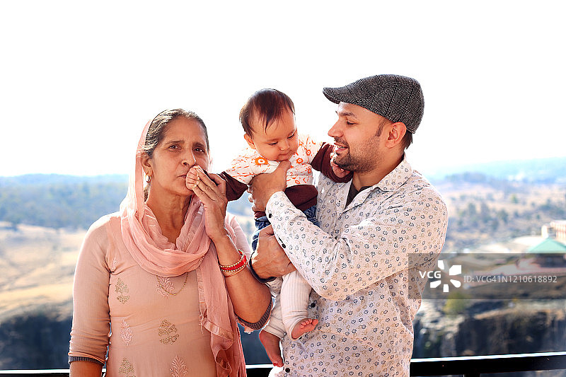 父亲抱着婴儿和母亲站在一起图片素材