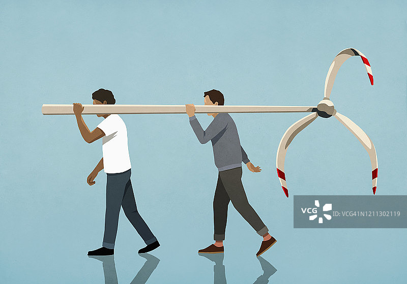 男人们扛着旧风力涡轮机图片素材