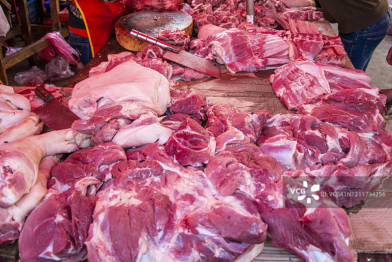 在老挝琅勃拉邦早市街头出售鲜肉的屠夫图片素材