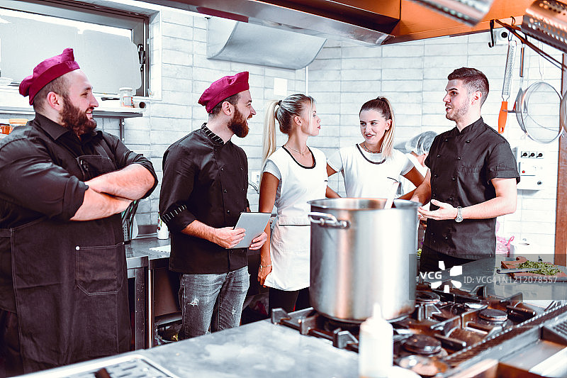忙碌的厨师团队讨论工作安排图片素材
