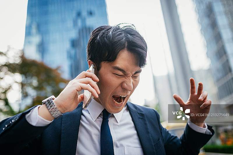 全球病毒导致亚洲企业遭受损失——韩国商人通过电话表达负面情绪图片素材