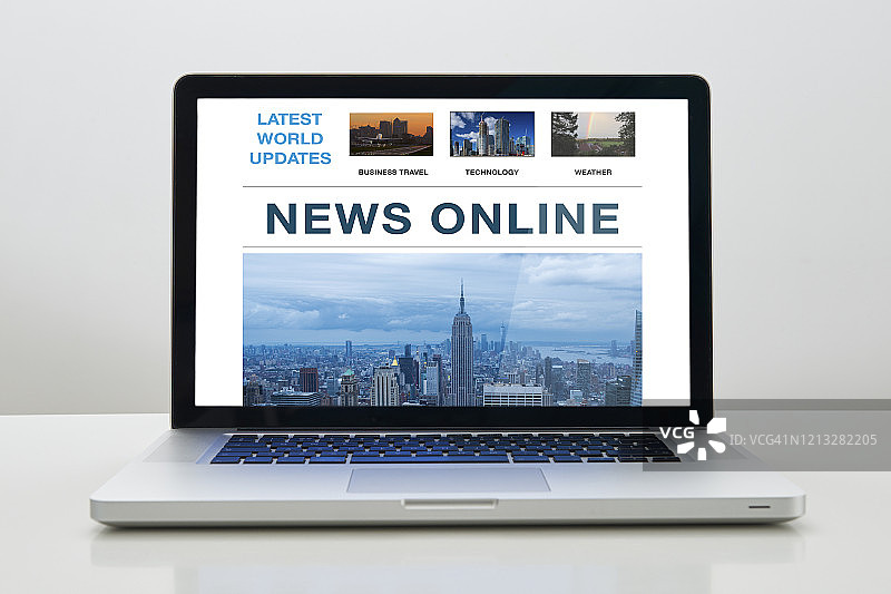 屏幕上显示在线新闻的笔记本电脑图片素材