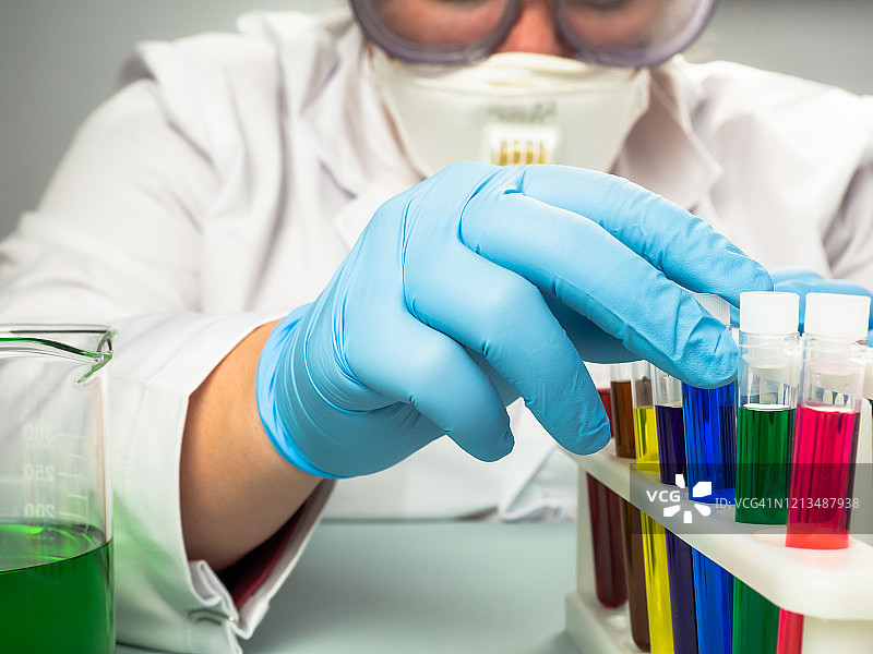 女医生或科学家在实验室分析彩色试管中的样本图片素材