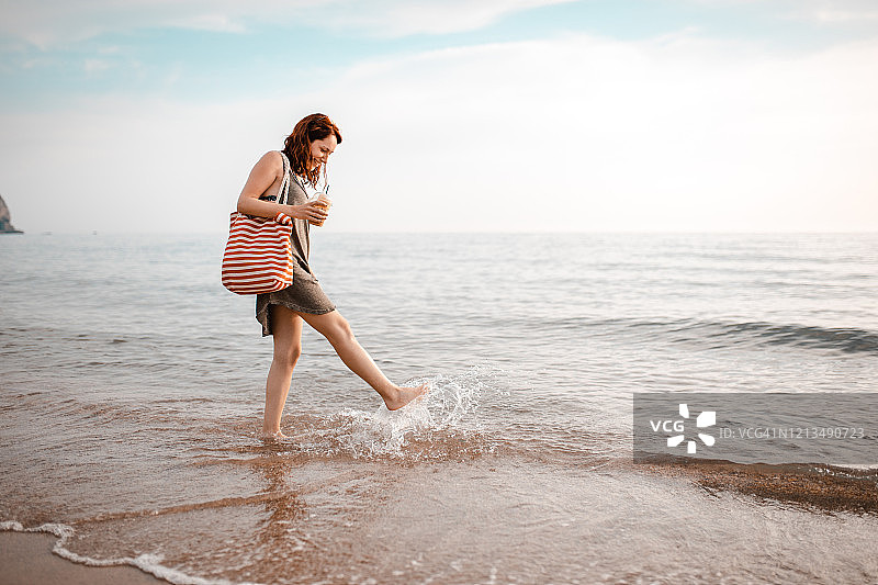 安详的女人在海边戏水图片素材