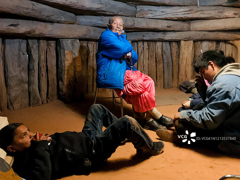 纳瓦霍家庭在传统Hogan小屋中祖母和两个孙子共度时光图片素材