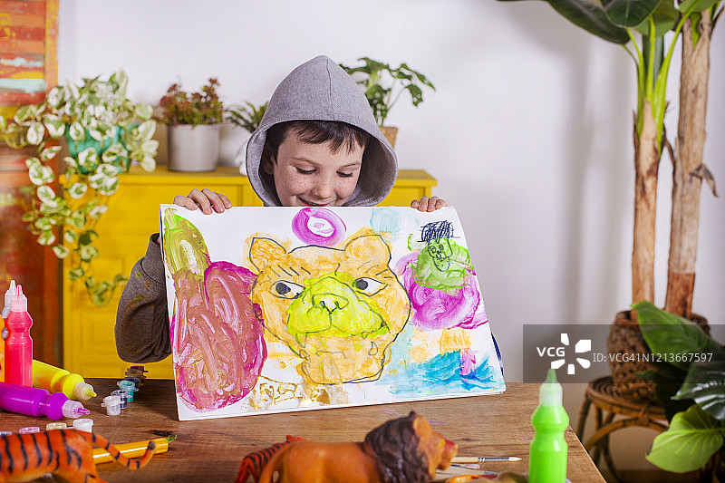 男孩在家展示他的画作图片素材