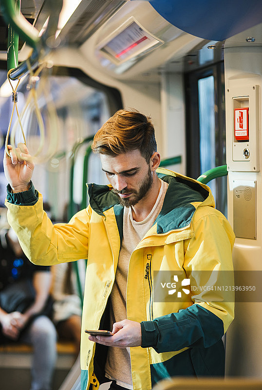 男人在地铁上使用手机图片素材