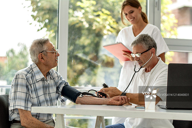 医生为老年男性测量血压图片素材