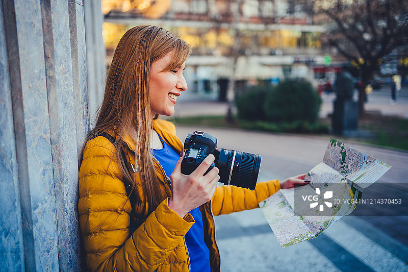 女游客用相机探索城市风光图片素材