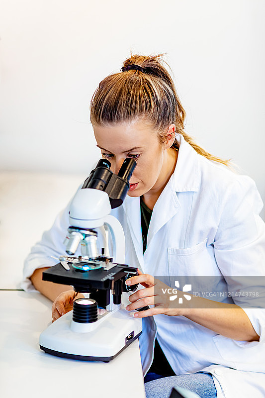 正在检查组织学样本的年轻女技师图片素材