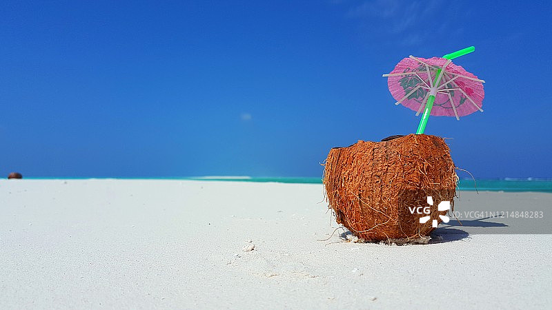 热带白沙滩上的新鲜椰子汁鸡尾酒，奢华度假风图片素材