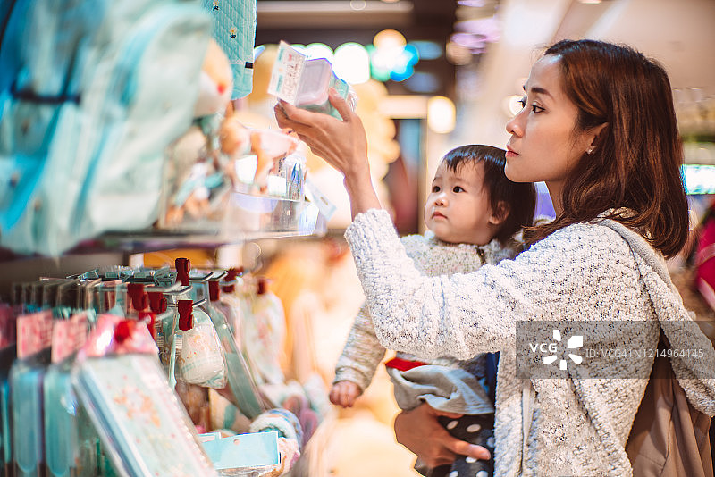 年轻妈妈和女儿在商店购物图片素材