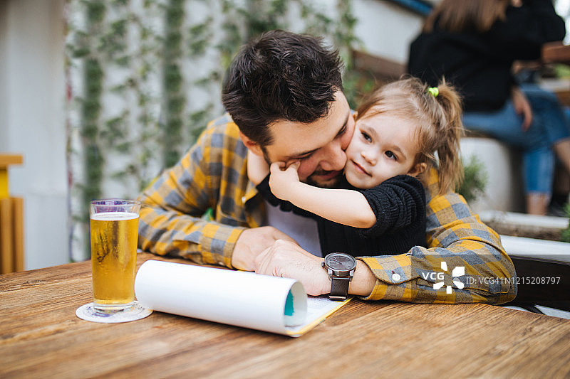 父亲和女儿在咖啡馆享受时光图片素材