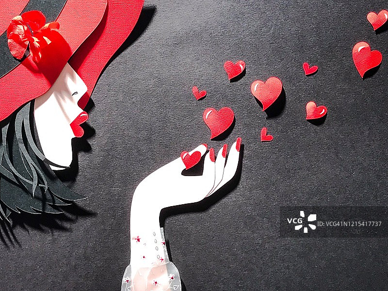 剪纸插画：戴着软红帽的女性头部，从手中送出爱心飞吻图片素材