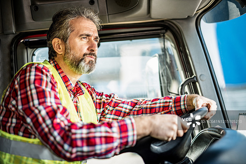 开卡车去仓库的成熟卡车司机图片素材