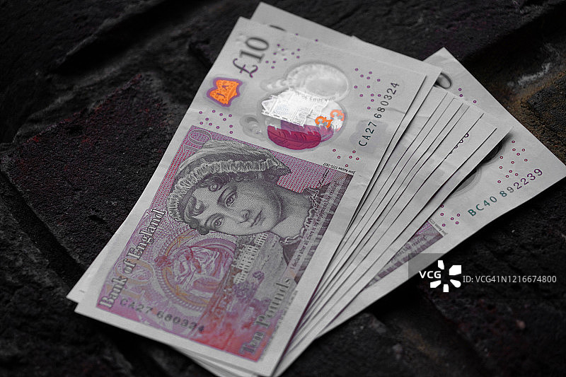 英镑纸币特写，疾病影响富人和穷人；金钱不可食用图片素材