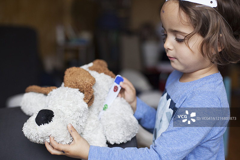 女孩和玩偶玩医生游戏的照片图片素材