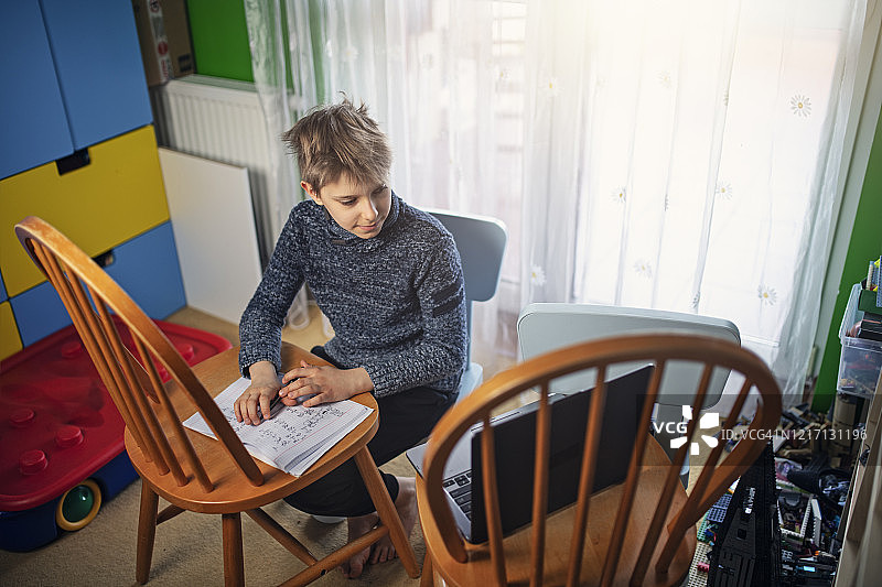 疫情期间，小男孩在家上网课图片素材