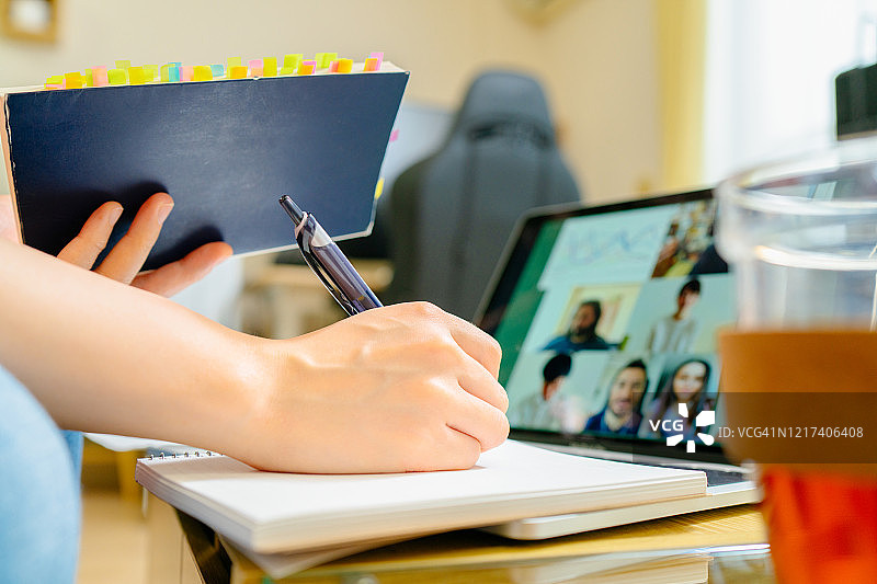 人手与大学生在家通过电话会议一起学习的特写照片图片素材