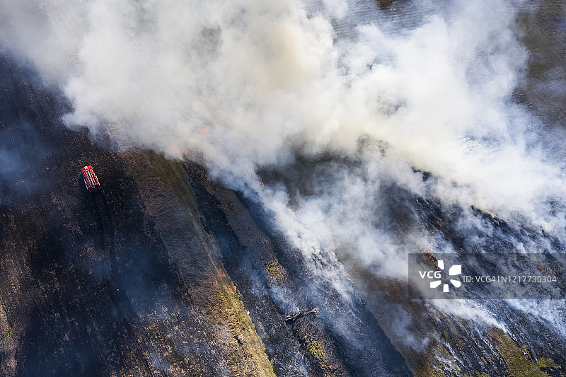 燃烧田野上的消防车：自然灾害图片素材