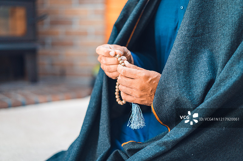 男子手持念珠祈祷图片素材