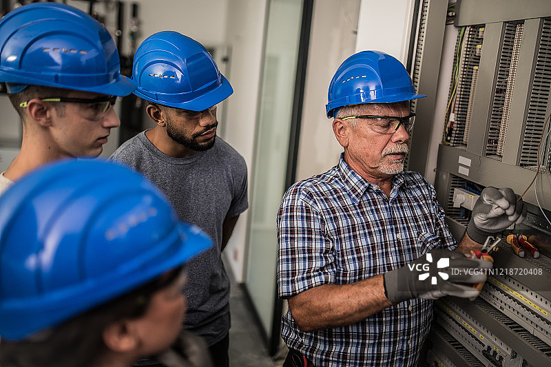 电工教导学徒剥线图片素材