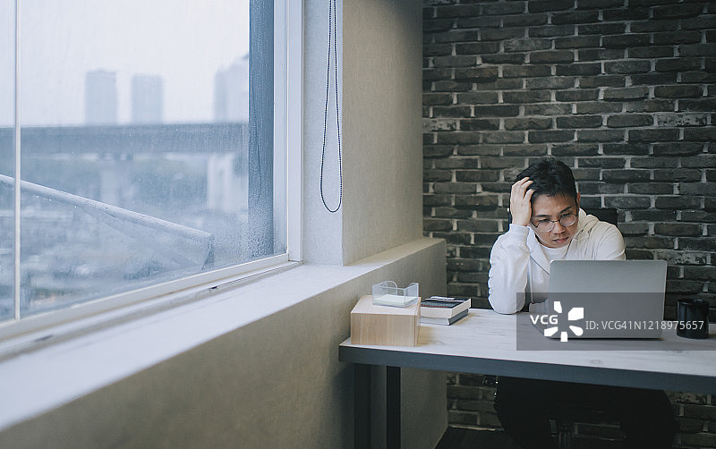 中年男人用笔记本电脑在线求职，情绪焦虑图片素材