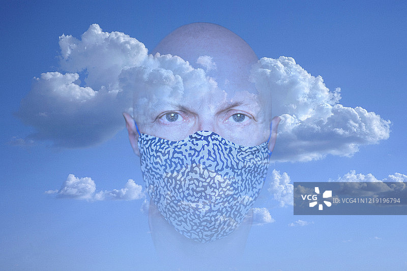戴口罩，头部在云端的男子肖像图片素材