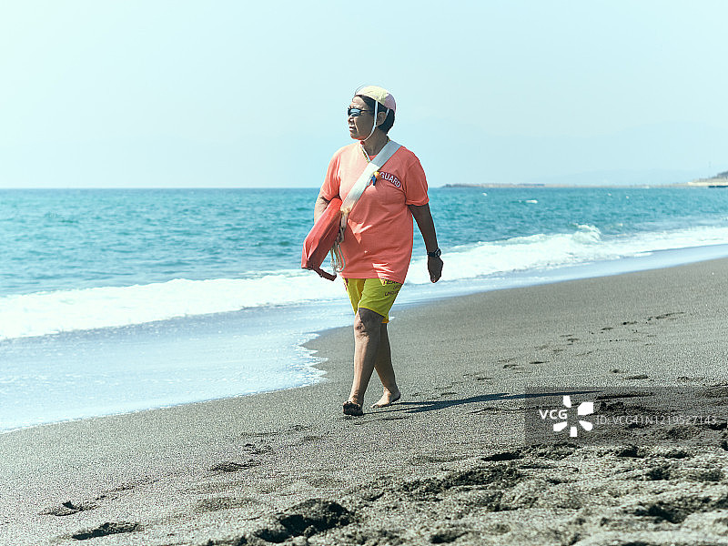 女救生员带着救生圈在海岸巡逻图片素材