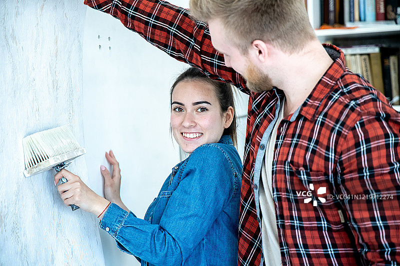 年轻夫妇正在装修他们的家。图片素材