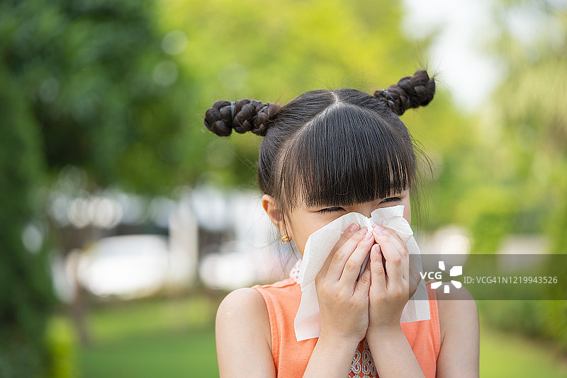 小女孩用纸巾擦鼻子图片素材