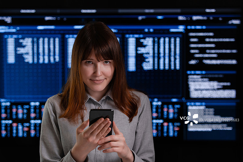 微笑的年轻女子手持手机图片素材