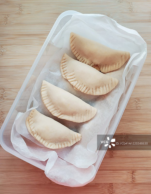 装满自制饺子的塑料容器图片素材