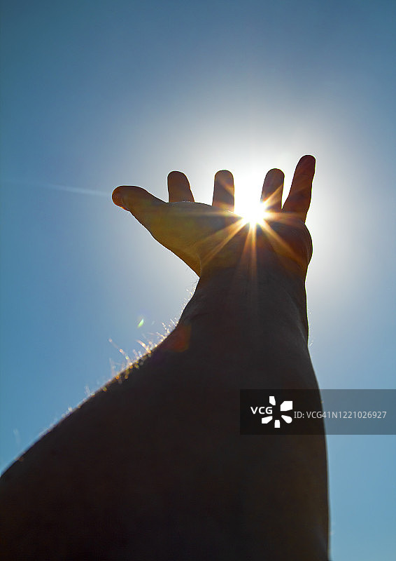 伸出手想要触摸太阳图片素材