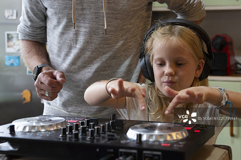 年轻女孩在厨房学习DJ技巧图片素材