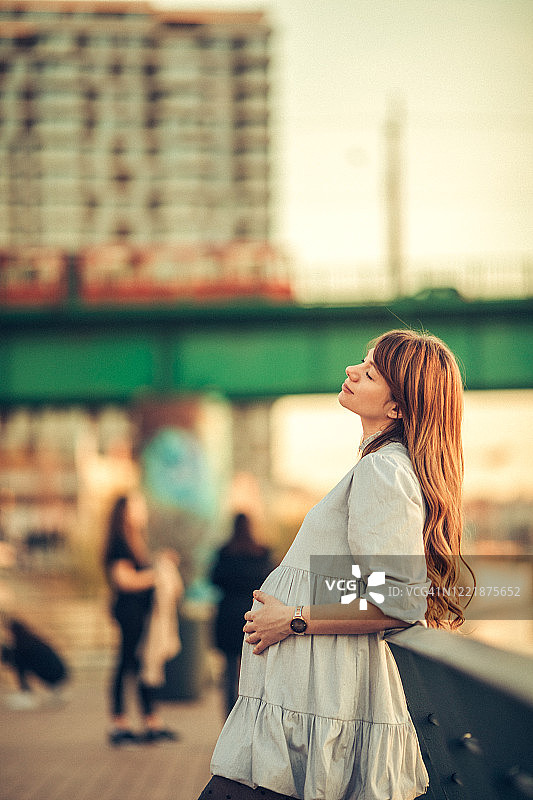 年轻孕妇在日落时分休息图片素材
