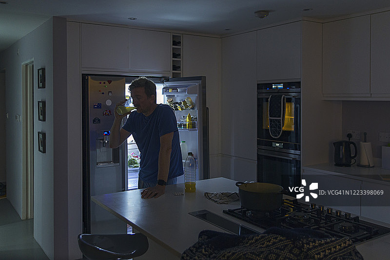 男人在半夜里喝饮料图片素材