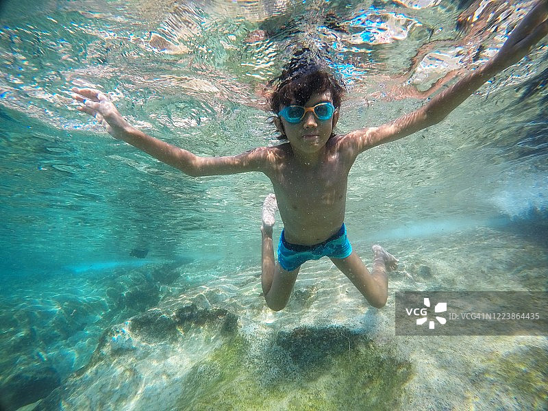 小男孩在泳池里水下游泳图片素材