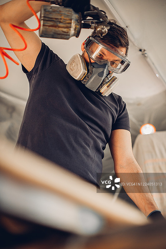 戴口罩的木匠使用喷漆枪图片素材