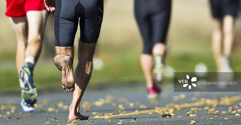 赤脚参加跑步比赛的运动员图片素材