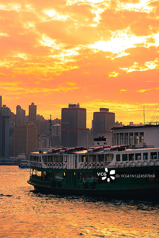 香港海港标志性摩天大楼城市景观的金色日出图片素材