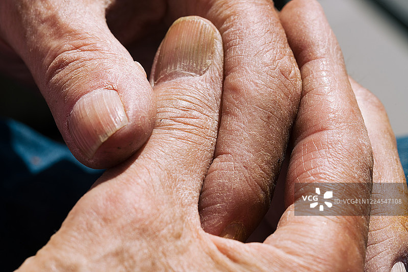 年长男性的饱经风霜的双手特写图片素材