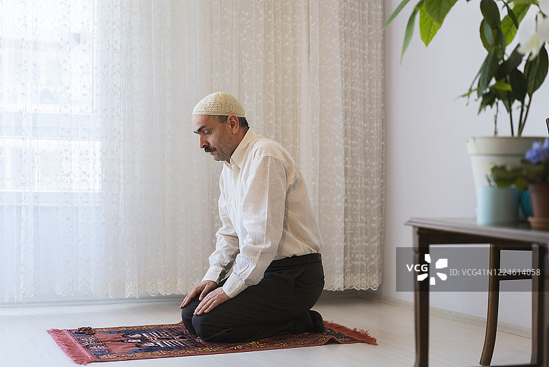 在土耳其斋月期间，穆斯林男子在家祈祷。图片素材